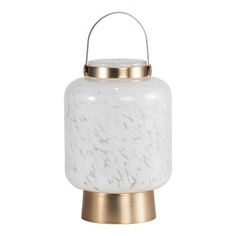 a white marble candle holder on a gold stand with a light fixture in the middle