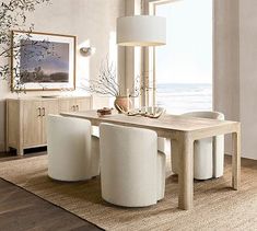 a dining room table with white chairs and a large window overlooking the ocean in front of it