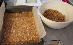 a pan filled with oatmeal next to a bowl full of granola