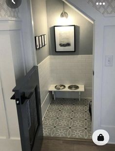 a dog bowl in the corner of a room with tile flooring and white walls