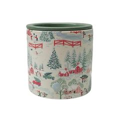 a ceramic pot with a winter scene on it