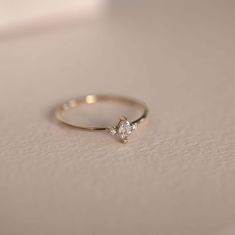 a diamond ring sitting on top of a table