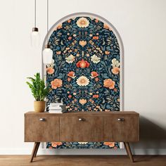 an ornate wallpaper design with flowers and leaves on a blue background in a living room