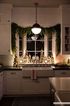 the kitchen is decorated for christmas with greenery