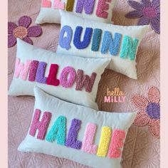 three decorative pillows with the word's name written on them