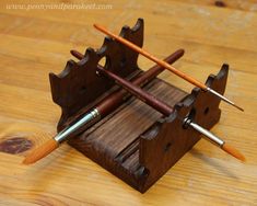 three wooden pencils are in a holder on a wood table with text overlay