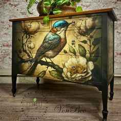 a bird painted on an old dresser with flowers