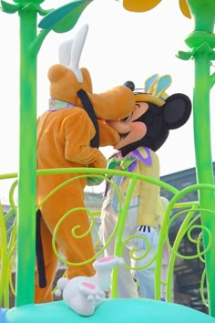 mickey and goofy kissing on top of a float