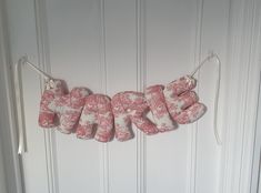 pink and white fabric letters hanging on the front door