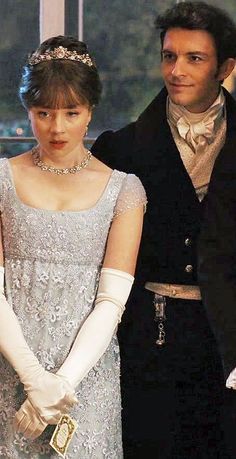 a man and woman dressed in period clothing