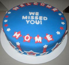 a blue cake with red, white and blue decorations on it that says we missed you