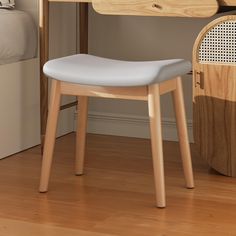 a white chair sitting in front of a wooden desk