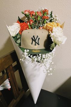 a baseball cap with flowers in it sitting on top of a table