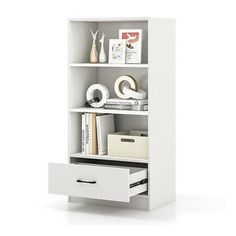 a white bookcase with two drawers and some items on it's shelfs