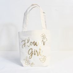 Details Product Detailsthe Flower Girl Can Hold All Of Their Flower Petals In A Metallic Gold Flower Girl Bag! This White Jute And Cotton Bag Features A Metallic Gold "Flower Girl" Headline And Metallic Gold Flower Designs. You Can Put The Flower Petals Inside This Bag For The Flower Girl. Watch The Flower Girl Shine As They Walk Down The Aisle With This Bag! 8in Wide X 3in Long X 7 1/2in Tall Attached Handles, 5in Drop Length New With Tags;Never Used Flower Girl Gift Bag, Gold Flower Girl, Walk Down The Aisle, Flower Girl Gifts, City Bag, Gold Flower, Party City, Wedding Board, Girls Bags