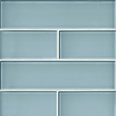 a close up shot of a light blue tile wall that has been painted in several different shades