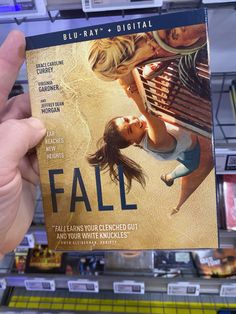 a person holding up a dvd cover for the movie's latest film, fall