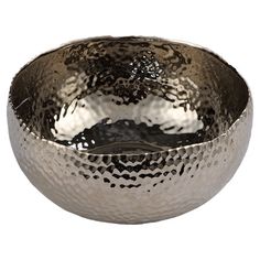 a large metal bowl sitting on top of a white table