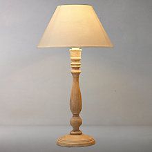 a wooden table lamp with a white shade