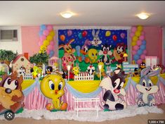 a room filled with lots of stuffed animals sitting on top of a floor next to a wall