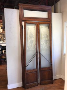 two wooden doors with frosted glass on them