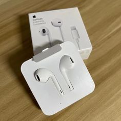 an apple earphones in its packaging on a table