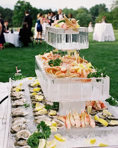 a large platter filled with lots of food sitting on top of a table covered in ice