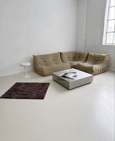 a living room with two couches and a coffee table in the middle of it