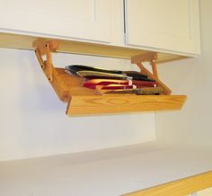 a wooden shelf holding knives and other kitchen items