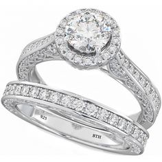 a white gold ring set with diamonds on the band and an oval shaped diamond in the center