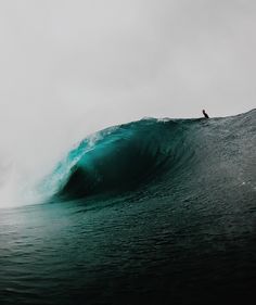 a person riding a wave on top of a surfboard