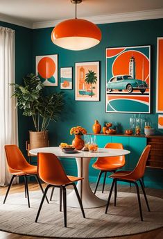 an orange and teal dining room with pictures on the wall above the dinning table