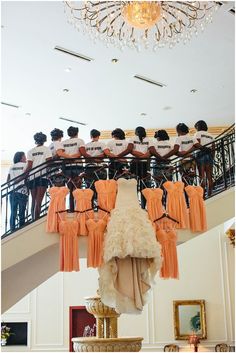 an instagram page with several dresses hanging from the ceiling and people standing in the background