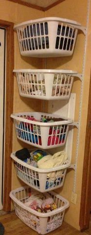 three baskets are stacked on top of each other in the corner of a kitchen area