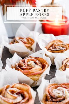 some cinnamon rolls sitting on top of white paper