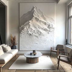 a living room filled with furniture and a large painting on the wall above it's coffee table