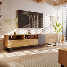 a living room filled with furniture and a flat screen tv on top of a wooden entertainment center