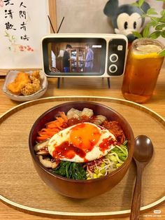 a wooden table topped with a bowl filled with food