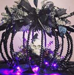 a skull in a basket with purple and black lights on it's head,