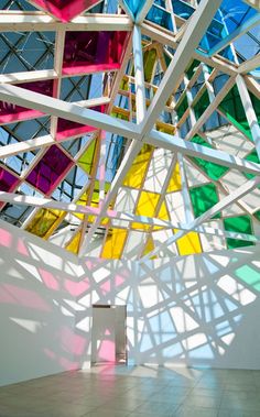 a room with many different colored glass pieces hanging from it's ceiling and floor