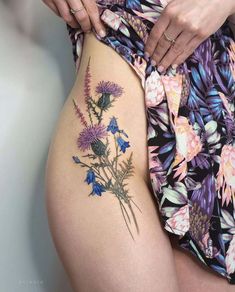 a woman's thigh with flowers on it