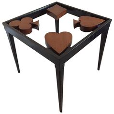 a wooden table with three hearts on it