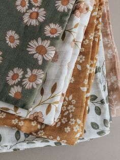 four different colored fabrics with flowers on them