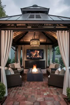 an outdoor living area with furniture and a fire pit