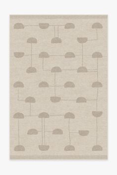 a beige rug with an umbrella pattern on the front and back of it, in neutral tones