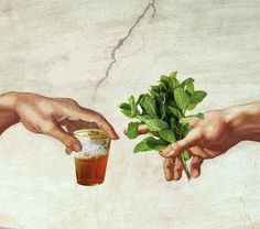 two hands reaching out towards each other over a cup filled with tea and mint leaves