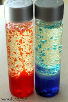 two bottles with different colored liquids in them