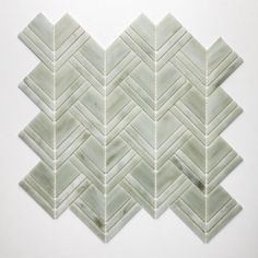 a white marble mosaic tile with an irregular pattern in the middle and diagonals on each side