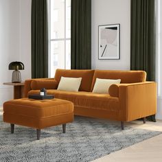 a living room with an orange couch and ottoman