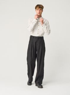 "Exquisite linen trousers for men -- flowy, pleated, and packed with details that ensure impeccable fit. Offered in heavy-weight linen. If you're interested in a medium-weight option, you'll find another THEO listing in our MEN'S section. STYLE DETAILS  * Relaxed fit * Wide, straight leg * High waist with elasticated back  * 2 front pleats * Fastens with 2 buttons and a zipper * Side pockets * Full length * Made from heavy-weight linen SIZES & COLORS IN PICTURES * Model wears size L in color Black Heavy and size M in color Magnetic Blue. He is 188 cm (6'2\"). Chest - 97 cm (38\"), waist - 83 cm (33\"), hips - 97 cm (38\"). NOTES ON SIZING & COLORS * Please note that linen shrinkage during the softening process cannot be predicted precisely. Therefore, each piece in the same size can vary 1 Male Linen Pants, Mens Flowy Fashion, Wide Trousers Outfit Men, Wide Pleated Pants Outfit Men, Relaxed Pants Outfit Men, High Waisted Trousers Men, Wide Fit Pants Men, Mens Wide Pants, Wide Pants Outfit Men